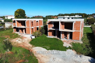 Houses in the shell construction phase within an exclusive residential project